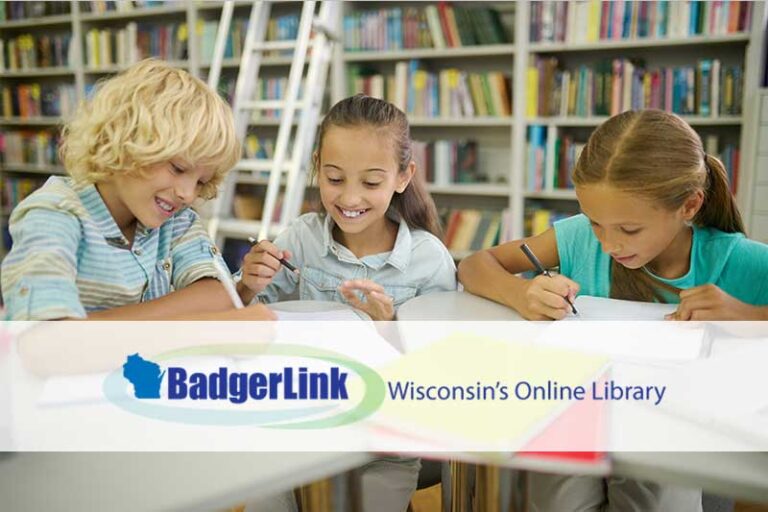 smiling children drawing and writing at a library table