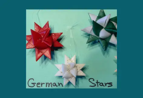 3 German Stars, created with blue, red, and green materials with glitter on them
